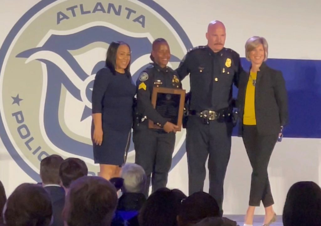 Katie Kirkpatrick Presents Award at APD Crime is Toast Breakfast